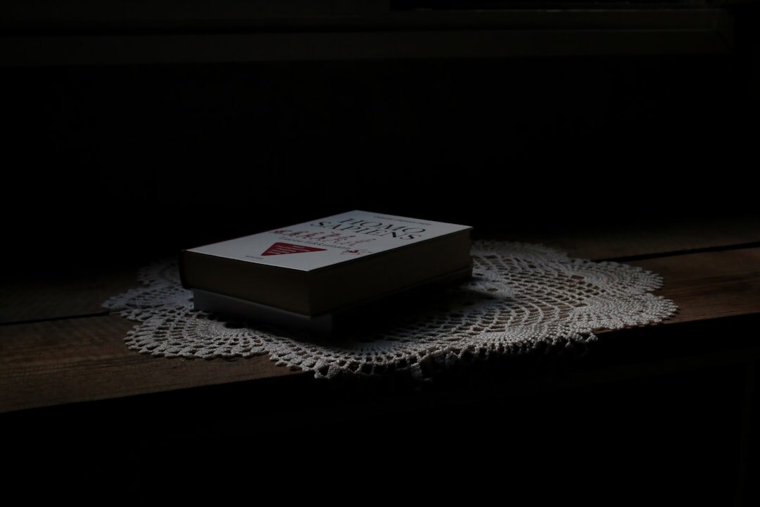 mystery novel on bedside table at night